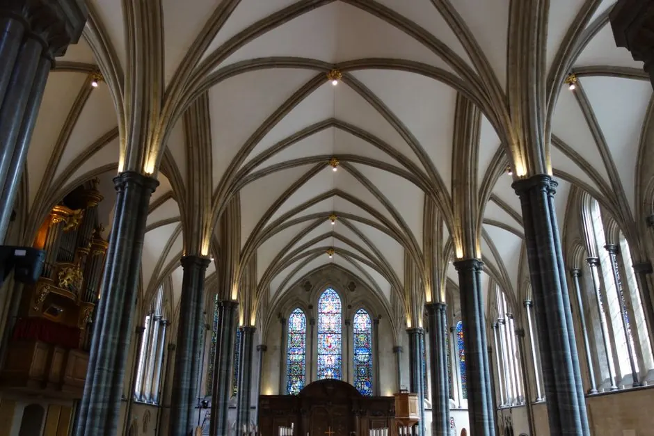 Stunning view of a Gothic cathedral's arched ceiling and stained glass windows.